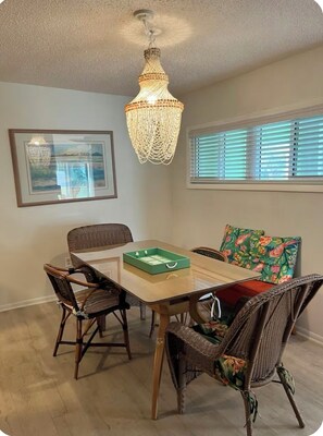 Dining room with shelf on left with linens and dishes