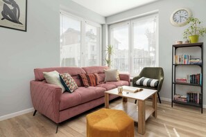 A cozy corner with a pink sofa invites you to relax with a book or a cup of coffee.