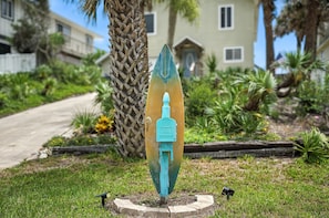 "Spot the surfboard mailbox and know you've arrived—where even the welcome sign promises beach adventures and endless fun ahead for your family getaway.