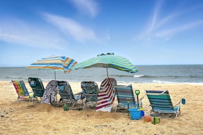 Your private beach oasis awaits with chairs for everyone to relax, umbrellas for perfect shade, and boogie boards ready for splash-filled adventures—where family beach days become pure magic.