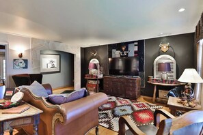 Cozy living room area with large TV and plenty of West Texas charm