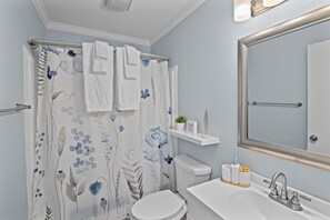 Private master bath with shower and tub combo, essentials & hair dryer.
