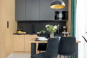 Kitchenette with plenty of kitchen utensils and dishes. 