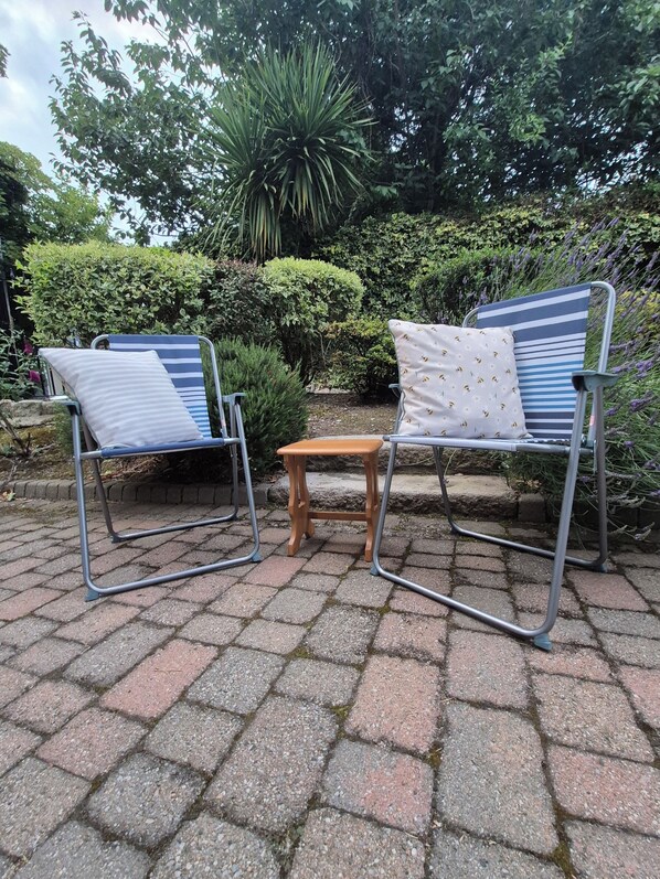 Double doors lead out to a Patio & Garden area, with Sea views.  