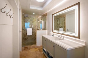 Refresh in a well-lit space where clean lines and warm tile create an atmosphere of everyday ease.