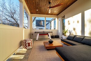 Second-floor patio, complete with a cozy lounging area and an air hockey table for fun and friendly competition.