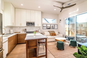 The open floor plan flows effortlessly into the living area, offering a warm and inviting space perfect for unwinding or gathering with loved ones.