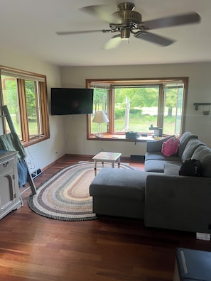 Cozy living room, sleeper couch, 50 in smart tv, natural light