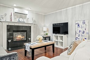 Living room with cozy sofa, fireplace, and smart TV for relaxing nights in.