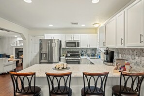 Barstool seating at the kitchen counter for casual dining and easy conversation.