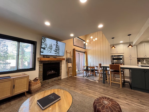 Living room with gas fireplace and 65" Smart TV