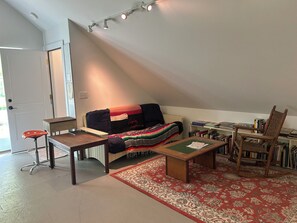 View of the secondary entrance on studio side and double futon.