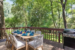 Patio with table set up for the dining are aand bbq