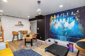 Entertainment area with karaoke stage, foosball, and seating area