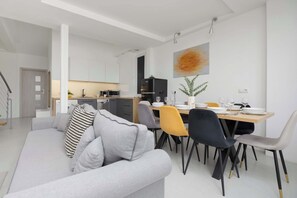 A wide view of the open-plan living and dining space, showcasing comfort and functionality.