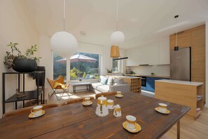 A stylish dining room with a large wooden table and elegant upholstered chairs.