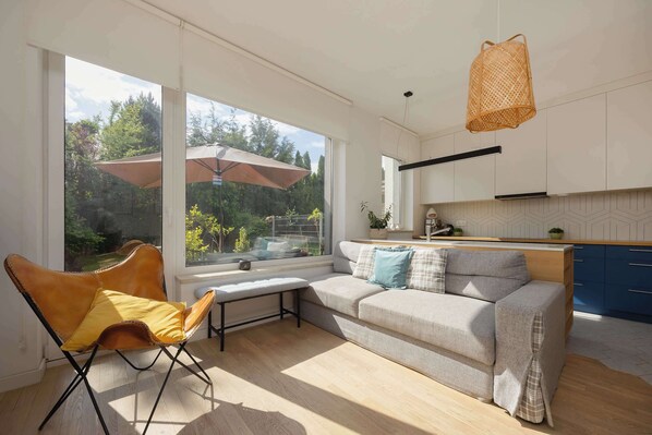 A cozy sitting area with a panoramic view of the green garden.