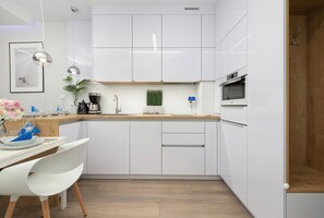 Kitchenette with oven and refrigerator. 