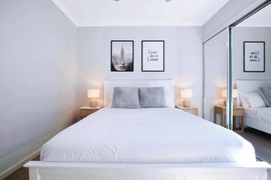 The second bedroom is equally well presented with a queen-sized bed, set with side tables and reading lights.
