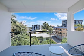 A seating nook on the balcony offers a peaceful spot to unwind with a book and enjoy some fresh air.