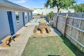 Property building with BBQ grill and outdoor seating area