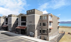 Water's Edge - E101 is a garden level unit with a walkout patio. (down one flight of stairs from parking level. Elevators will be operational August 1st, 2025)