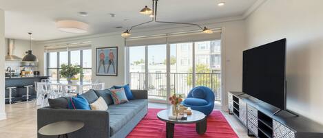 Living room off the balcony featuring a sleeper sofa.