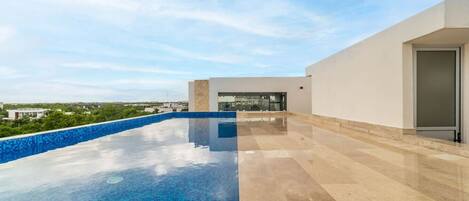 Relax by the rooftop pool with sunset vibes.