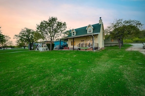 Backyard with hammock, propane grill, and covered seating area.