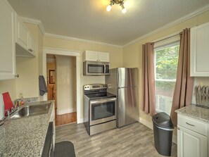 Newly renovated, fully stocked kitchen with granite counters