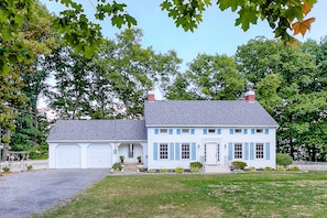 Exterior view, front of house has large yard for sunning or games.