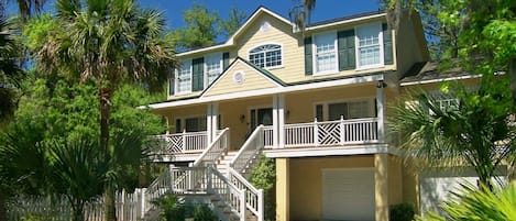 Front of home facing Nighthawk Street, with rocking chairs and breakfast table.