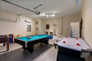 The Game room has a pool table, air hockey, foosball, & Air Conditioning