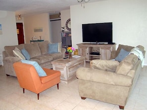 Large living room opens to lanai.  Has queen size sleeper sofa and 55-inch TV.