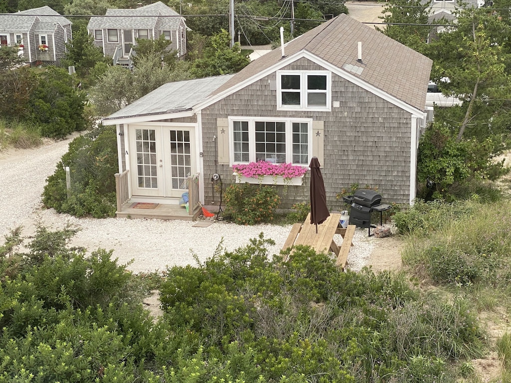 Cape Cod style cottage with private driveway nestled in the trees.