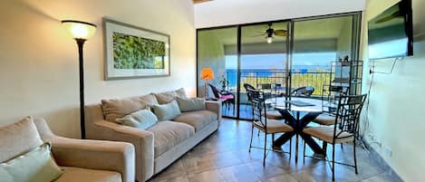 Living room with lanai in background and ocean views. 