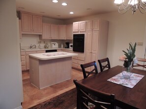 Modern kitchen with appliances and coffee station.