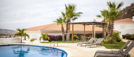 Relax on the lounge chairs next to the pool!