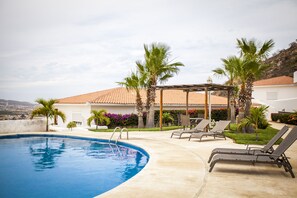 Relax on the lounge chairs next to the pool!