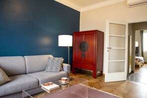 Living room and bedroom in the background on the right.