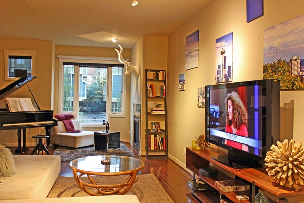Spacious living room with modular sofa, big screen TV and LED lighting