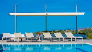 The pool area with a large pergola. The swimming pool is heated on demand.