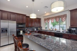 Kitchen with high-end appliances & granite countertops