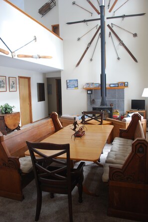 Antique church pews and end chairs seat 10 around the dining table.