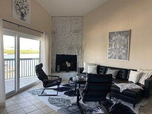 Large, open living room with plenty of seating and water views