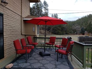 6 deck chairs w/ 3 side tables, cushions, and umbrella: close when not using.