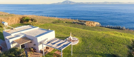 Drone view of house with Africa in background