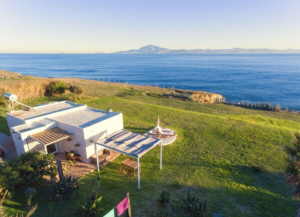 Drone view of house with Africa in background