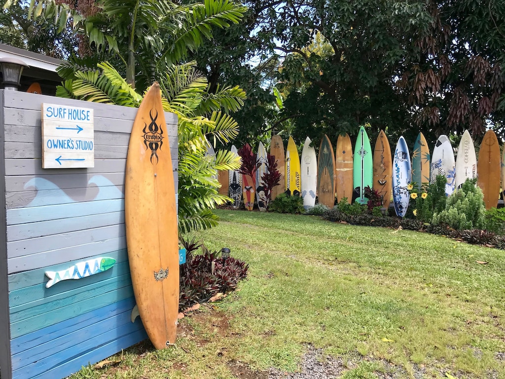 Collection of colorful surfboards around an Airbnb in Maui