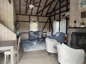 Open area living with cathedral beamed ceilings